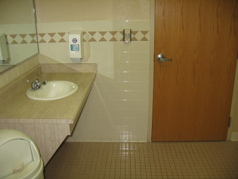 Sink in accessible restroom with space underneath for wheelchairs